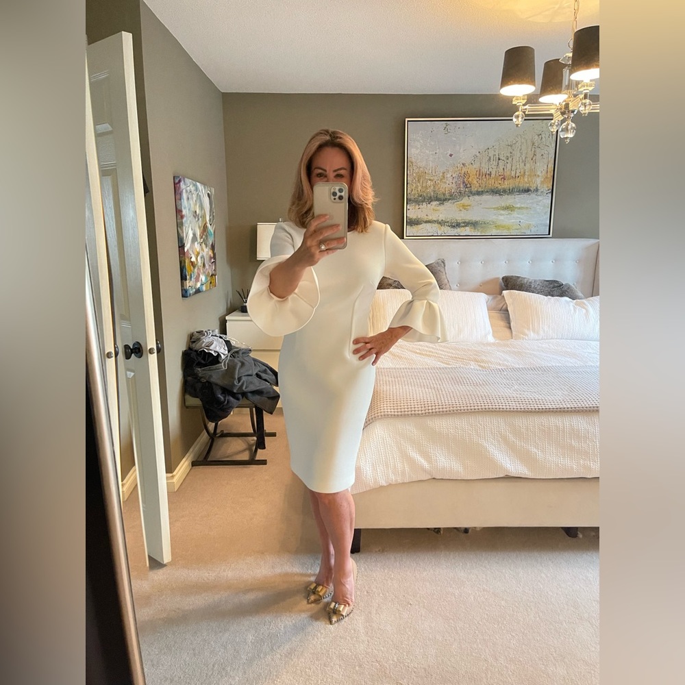 White dress with a bell sleeve, size 8, stretchy fabric. Never worn!